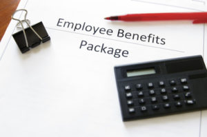 employee benefits package with calculator and pen