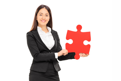 Businesswoman holding a piece of a puzzle isolated on white background