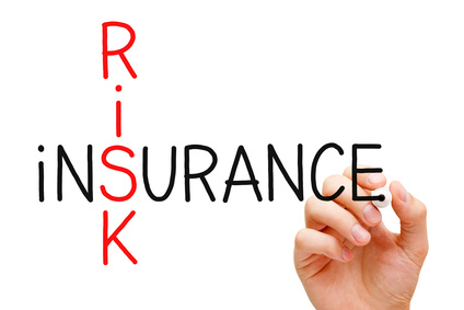 Hand writing Risk Insurance crossword with marker on transparent wipe board.